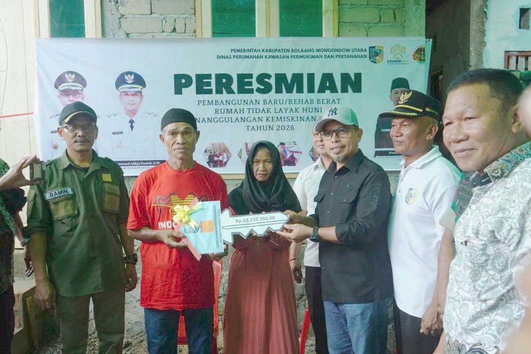 Bupati Bolmut Sirajudin Lasena menyerahkan kunci Rumah Layak Huni kepada warga Desa Ollot I